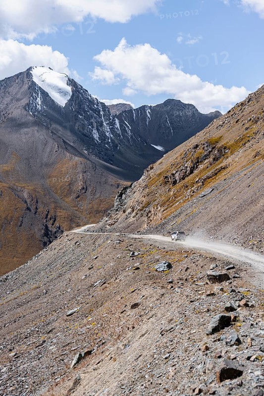Off-road car on mountain pass, gravel road in the mountains in the Tien Shan, Engilchek Valley, Kyrgyzstan, Issyk Kul, Kyrgyzstan, Asia