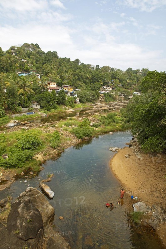 Indian people washing clothes in the Periyar River, Mundakayam, Kerala, India, Asia