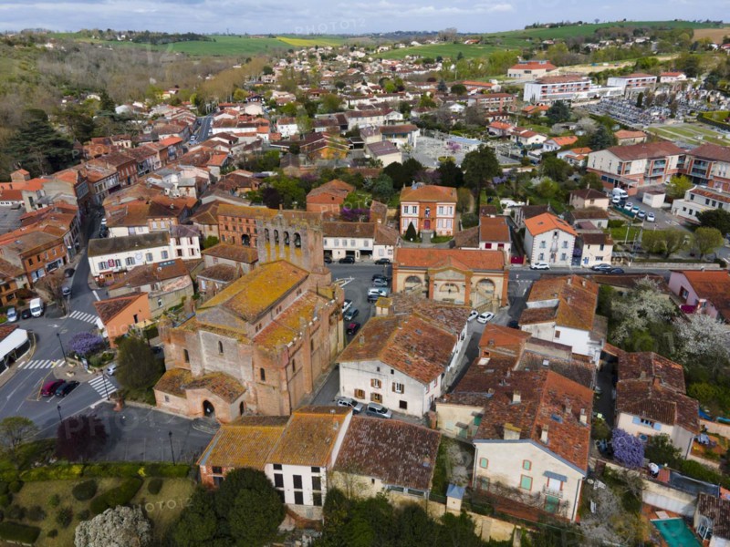 Aerial view of a small town with historic architecture and streets surrounded by landscape, parish church Eglise Saint-Pierre-et-Saint-Phebade, Venerque, Haute-Garonne, Occitania, France, Europe