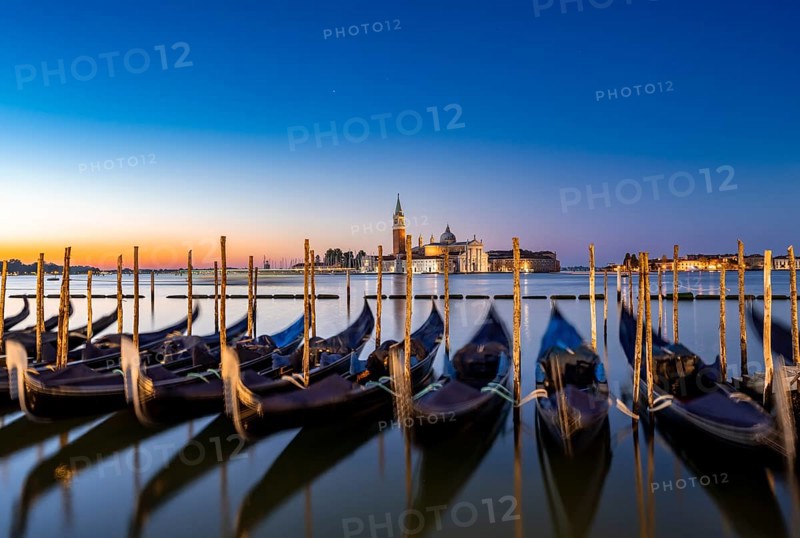 Venetian gondolas, boat dock at St Mark's Square, church of San Giorgio Maggiore in the background, long exposure at sunrise, Venice, Veneto, Italy, Europe