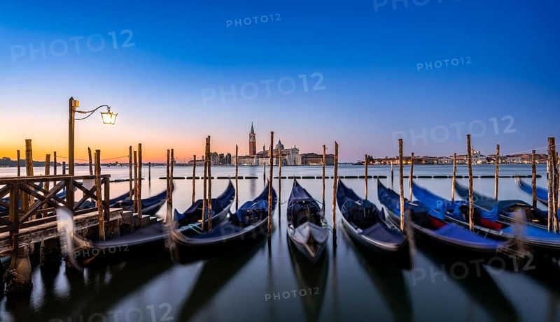 Venetian gondolas, boat dock at St Mark's Square, church of San Giorgio Maggiore in the background, long exposure at sunrise, Venice, Veneto, Italy, Europe