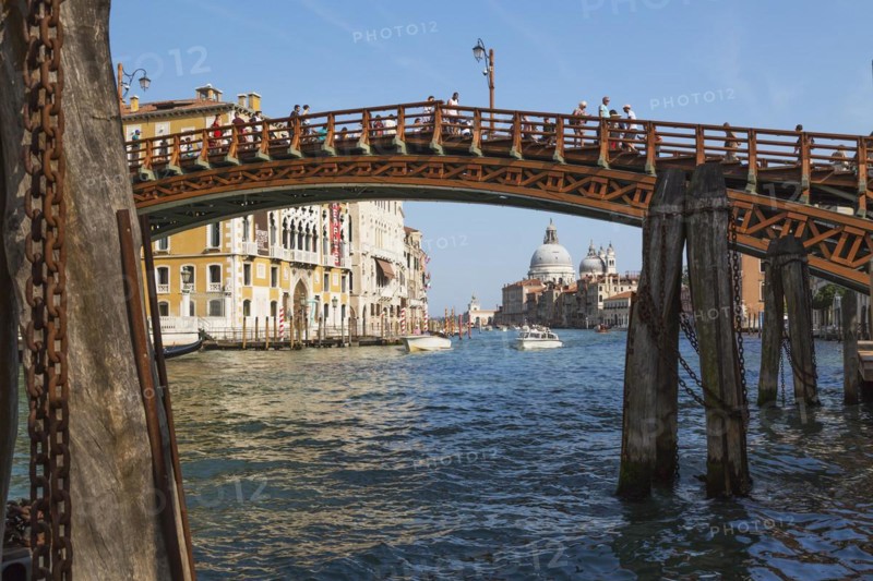 Accademia footbridge over Grand Canal with water taxis, Renaissance architectural style residential palace buildings and Santa Maria della Salute basilica, Dorsoduro district, Venice, Veneto, Italy, Europe