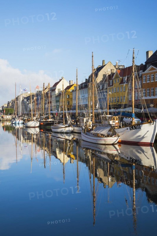 Moored sailboats and colourful 17th century apartment buildings and houses along the Nyhavn canal, Copenhagen, Denmark, Europe
