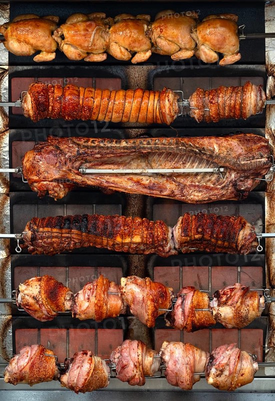 Flame wall grill with chicken possibly Turkey, ribs, pork knuckle in the marquee at the spring festival Deggendorf, Lower Bavaria, Bavaria, Germany, Europe