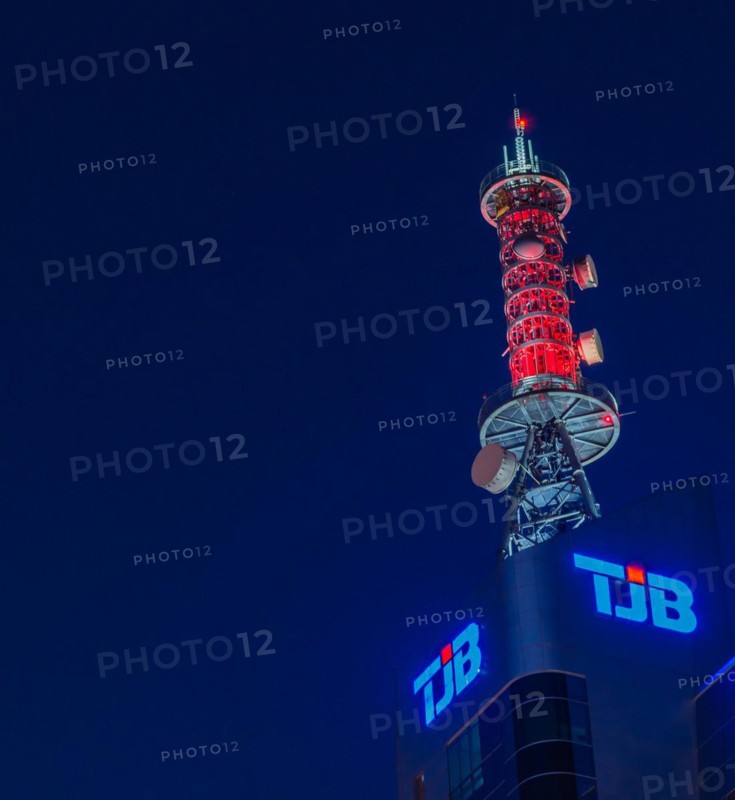 Communication array lit up with red lights on roof of TJB tower at blue hour inDaejeon, South Korea, Asia