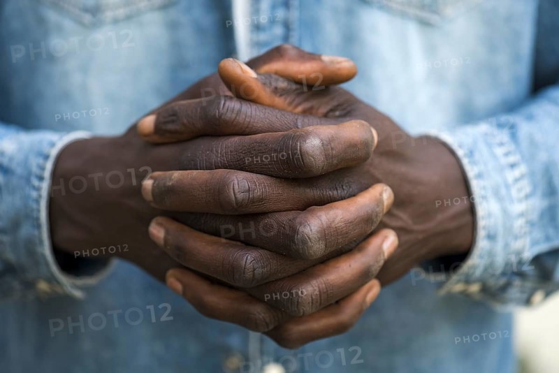 Folded hands of an African migrant, Bavaria, Germany, Europe