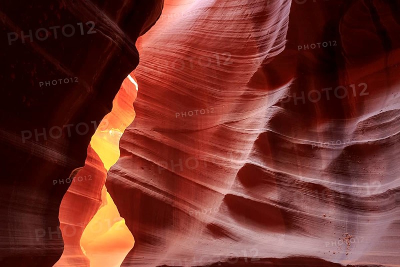 Warm rays of sunlight illuminate the undulating structures inside a rock cave, Upper Antelope Canyon, North America, USA, South-West, Arizona, North America