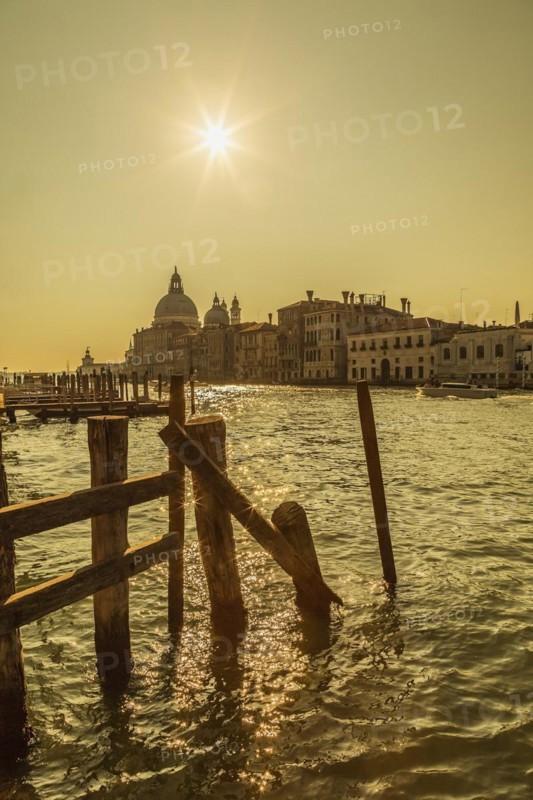 Silhouetted view of Grand canal with water taxis and Santa Maria della Salute basilica in Dorsoduro, Venice, Veneto, Italy, Europe
