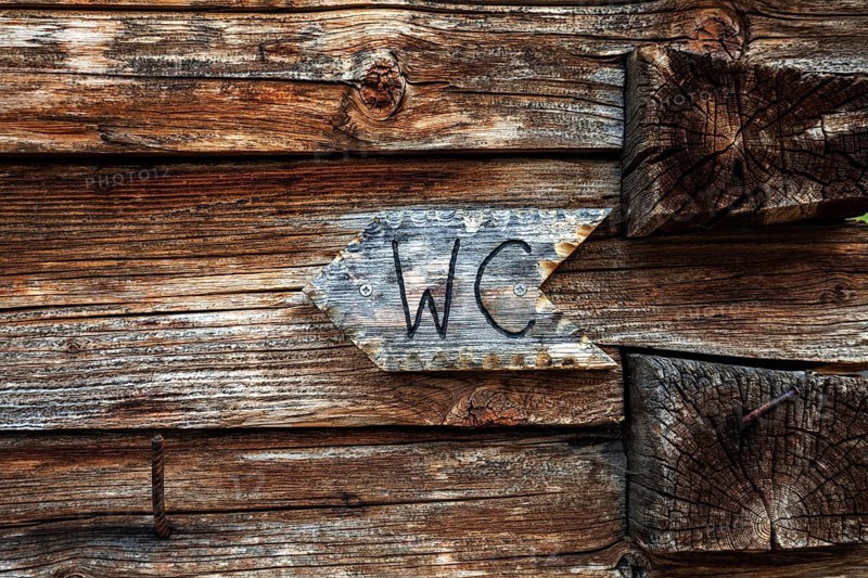 WC sign on the wooden wall of the Naturalpe Gemstel-Schoenesboden-Alpe, Gemsteltal, Mittelberg, Kleinwalsertal, Vorarlberg, Allgaeu Alps, Austria, Europe