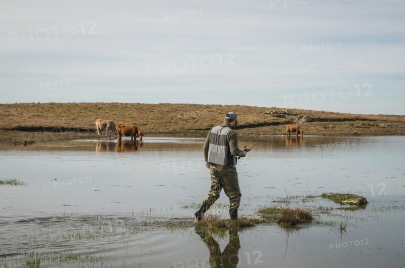 Sport fisherman fishing in lake on cloudy day, Cambara do sul, Rio Grande do sul, Brazil, South America