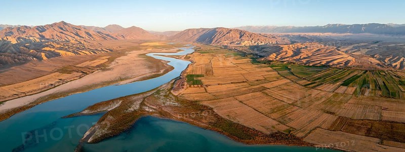 Naryn River between mountains and fields, at Toktogul Reservoir at sunset, aerial view, Kyrgyzstan, Asia