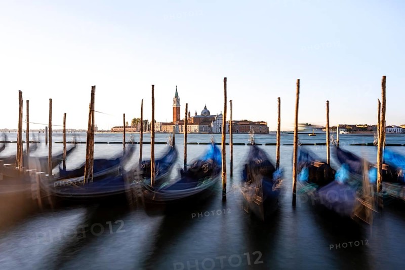 Venetian gondolas, boat dock at St Mark's Square, church of San Giorgio Maggiore in the background, long exposure in the morning light, Venice, Veneto, Italy, Europe