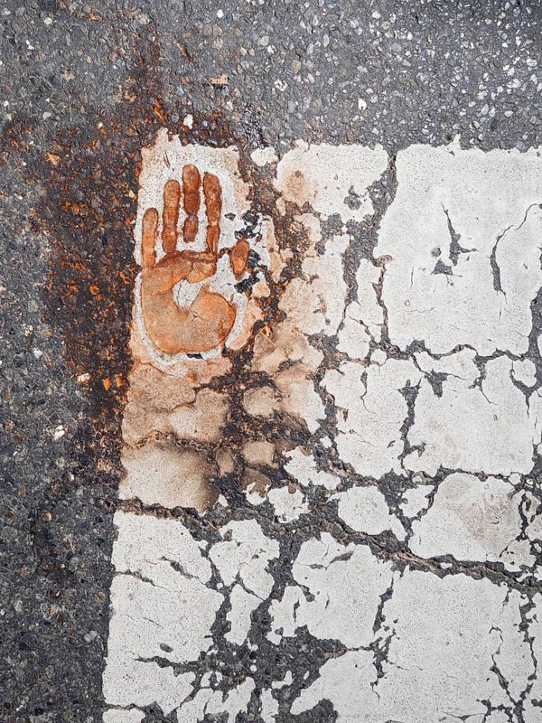 Handprint on a zebra crossing, after removal of a climate sticker, Leoben, Styria, Austria, Europe