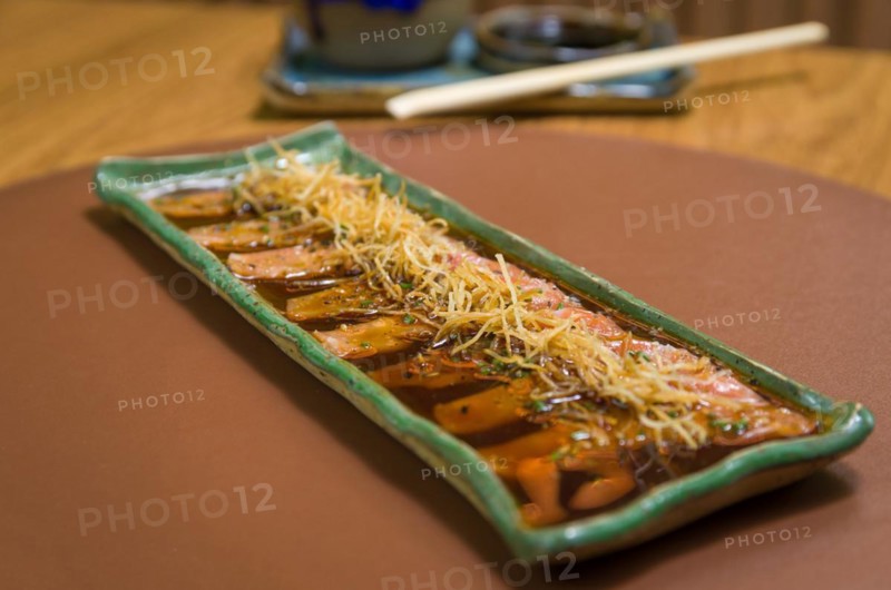 Delicious premium salmon sashimi arranged on an elegant handmade platter