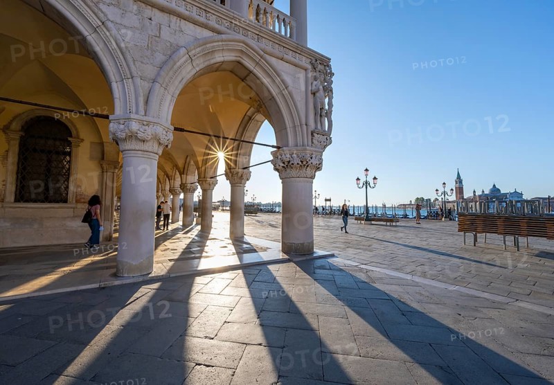 Colonnade of the Doge's Palace with Sun Star in the Piazetta San Marco, St Mark's Square, Venice, Veneto, Italy, Europe