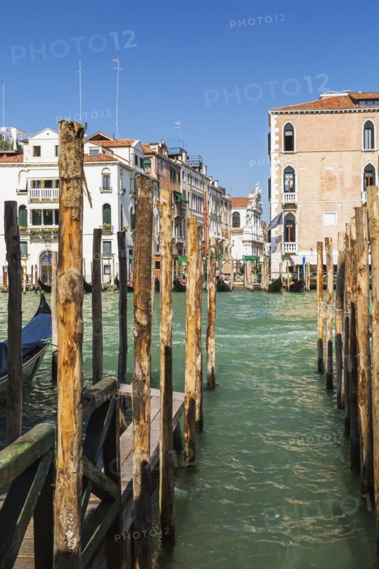 Mooring poles and gondola on Grand Canal with Renaissance architectural style residential palace buildings, San Marco, Venice, Veneto, Italy, Europe