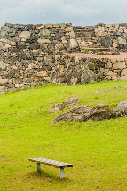 Remains of Japanese stone fortress with park bench in foreground in Suncheon, South Korea, Asia