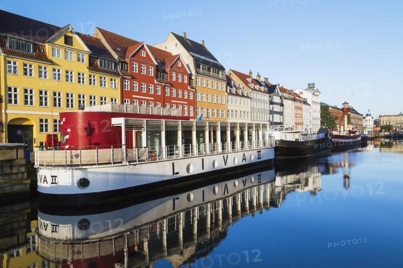 Moored Liva II restaurant boat, ships and colourful 17th century apartment buildings and houses along the Nyhavn canal, Copenhagen, Denmark, Europe
