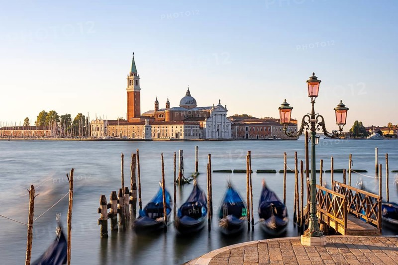 Venetian gondolas, boat dock at St Mark's Square, church of San Giorgio Maggiore in the background, long exposure in the morning light, Venice, Veneto, Italy, Europe