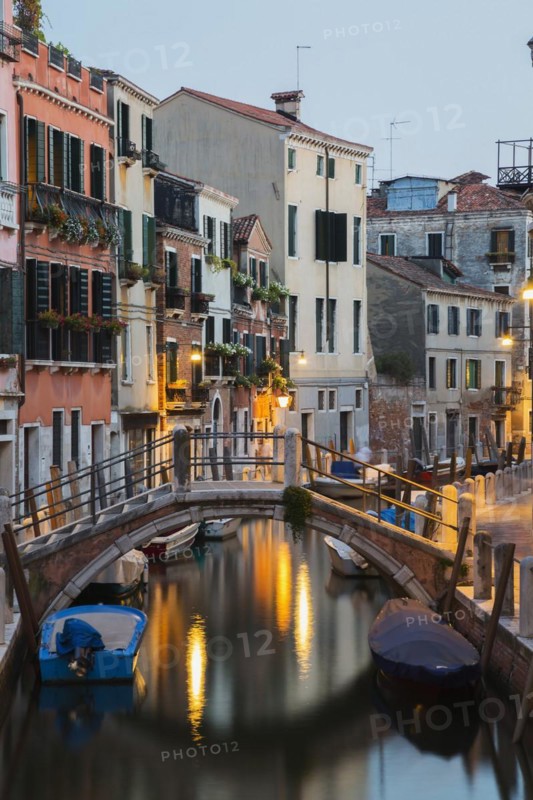 Moored boats and footbridge over Rio de la Toletta Canal with old architectural style residential buildings at dusk, Dorsoduro district, Venice, Veneto, Italy, Europe