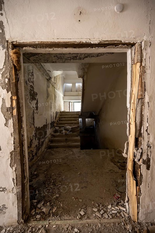 A damaged staircase in a dilapidated building with falling paint and debris at the entrance, ghost town, Engilchek, Tian Shan, Kyrgyzstan, Asia