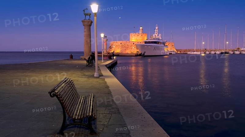 Quiet harbour promenade with bench and lamppost opposite fort and boats in moonlight, night shot, Deer statue, luxury yacht, Fort of Saint Nikolaos, harbour promenade, Rhodes, Dodecanese, Greek Islands, Greece, Europe