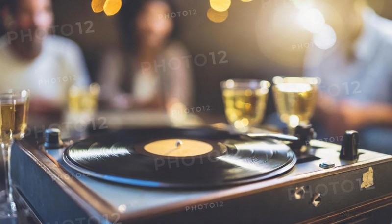 A turntable playing a vinyl record with champagne glasses and festive defocused lights in the background, AI generated