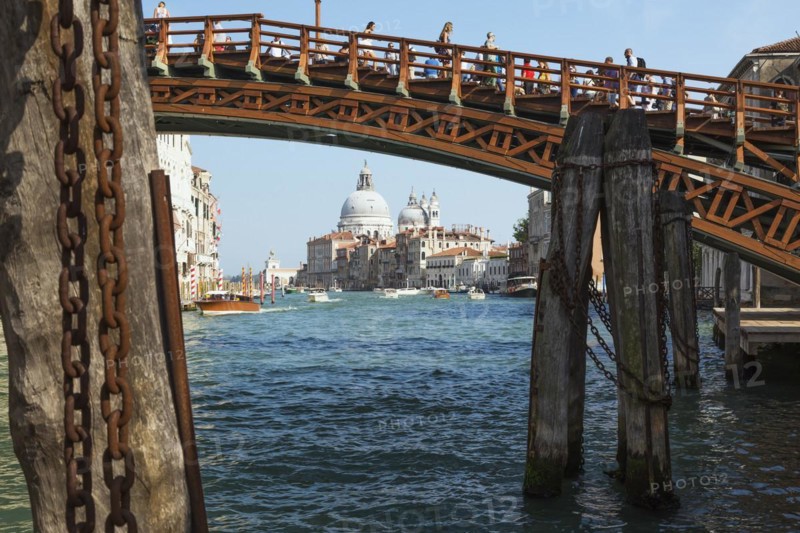 Accademia footbridge over Grand Canal with water taxis, Renaissance architectural style residential palace buildings and Santa Maria della Salute basilica, Dorsoduro district, Venice, Veneto, Italy, Europe