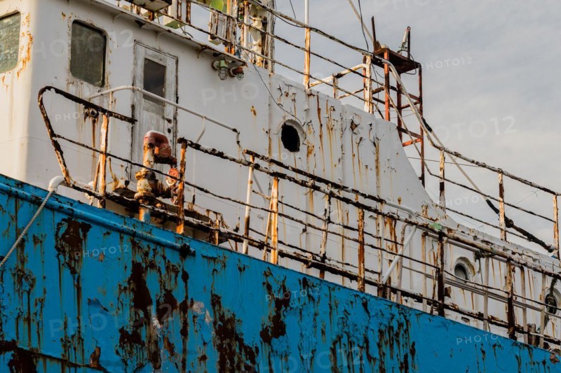 Closeup of side old rusty abandoned ship taken at a marine junkyard in South Korea