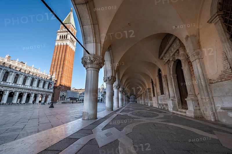 Colonnade of the Doge's Palace with Campanile bell tower in Piazetta San Marco, St Mark's Square, Venice, Veneto, Italy, Europe