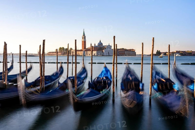 Venetian gondolas, boat dock at St Mark's Square, church of San Giorgio Maggiore in the background, long exposure in the morning light, Venice, Veneto, Italy, Europe