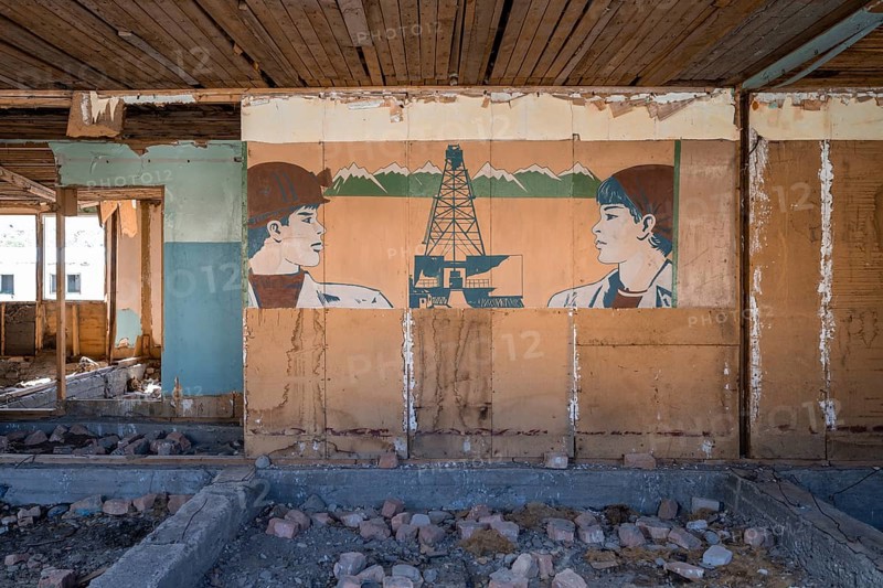 Destroyed abandoned classroom of the old school, wall painting with Soviet miners, ghost town, Engilchek, Tian Shan, Kyrgyzstan, Asia