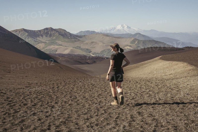 Young woman walking through lava fields, Crater Navidad, Lonquimay volcano, Malalcahuello National Reserve, Curacautin, Araucania, Chile, South America