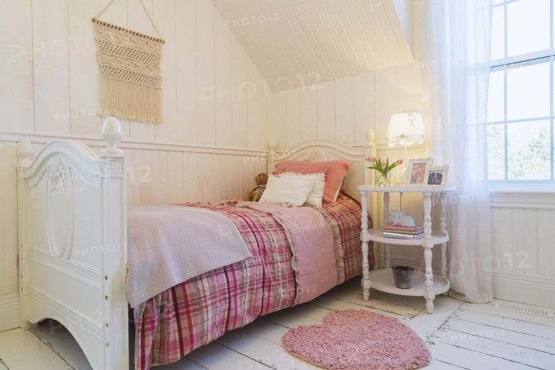Single bed with red, pink and grey tartan bedspread, white painted antique style wooden headboard and footboard, nightstand in a kid's bedroom with white painted larch wood floorboards on upstairs floor inside country style home, Quebec, Canada, North America