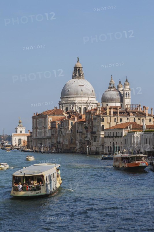 Vaporettos and water taxis on Grand Canal with Renaissance architectural style palace buildings and Santa Maria della Salute basilica, Dorsoduro district, Venice, Veneto, Italy, Europe