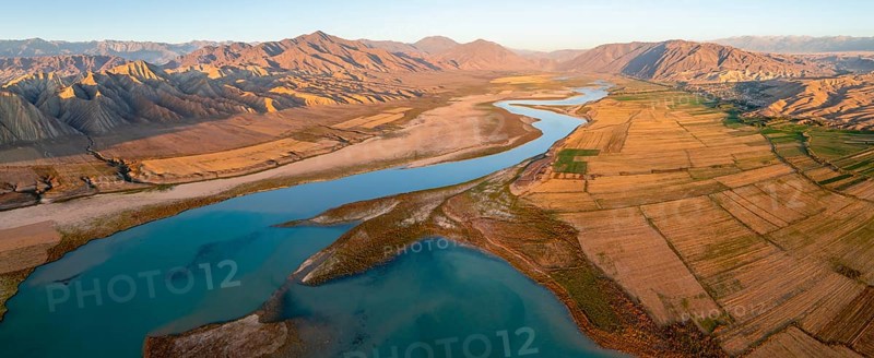 Naryn River between mountains and fields, at Toktogul Reservoir at sunset, aerial view, Kyrgyzstan, Asia