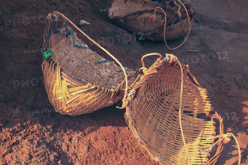 Close up of three woven wicker baskets that are used to gather and carry harvested salt in Kampot Cambodia that shows the authentic and traditional khmer local product