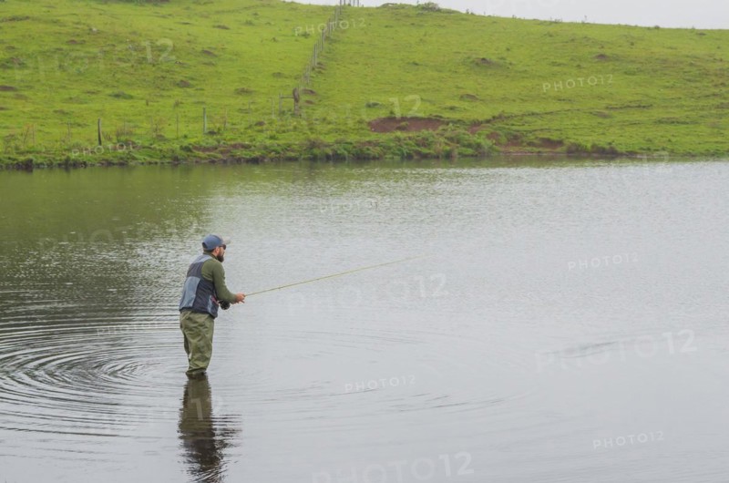 Black bass fisherman fishing inside lake, Cambara do sul, Rio Grande do sul, Brazil, South America