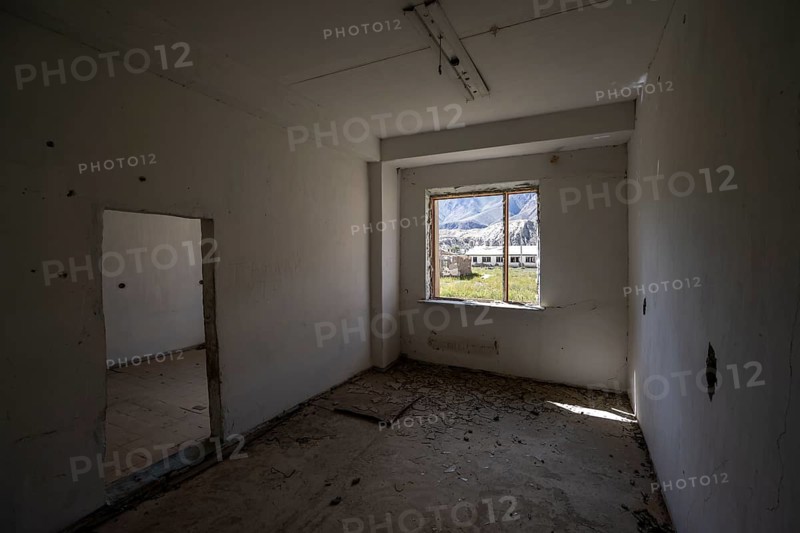 An abandoned, dilapidated room with a view of the mountains through the window, ghost town, Engilchek, Tian Shan, Kyrgyzstan, Asia