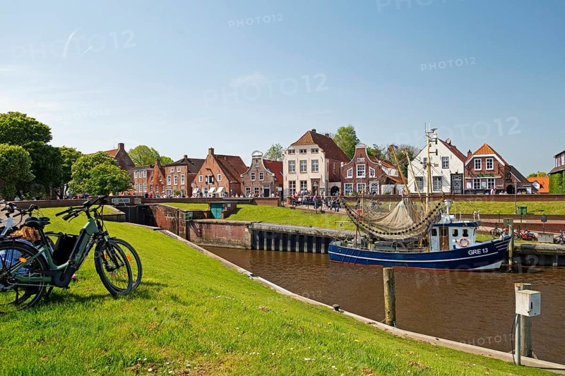 Picturesque cutter harbour, Greetsiel, ebikes, gabled houses, Krummhoern, East Frisia, Germany, Europe