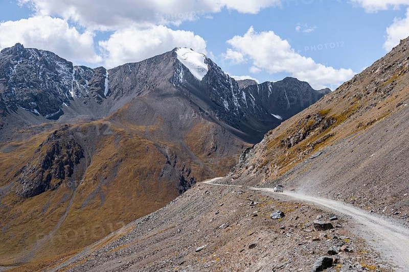 Off-road car on mountain pass, gravel road in the mountains in Tien Shan, Engilchek Valley, Kyrgyzstan, Issyk Kul, Kyrgyzstan, Asia