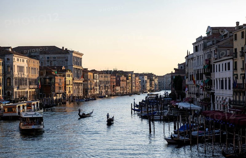 View over the Grand Canal with gondolier and vaporetto in the evening light, from the Rialto Bridge, Venice, Veneto, Italy, Europe