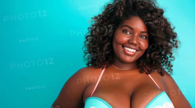 A plus size black afro-american bikini model with curly hair is smiling and wearing a bikini top. Concept of confidence and happiness, AI generated