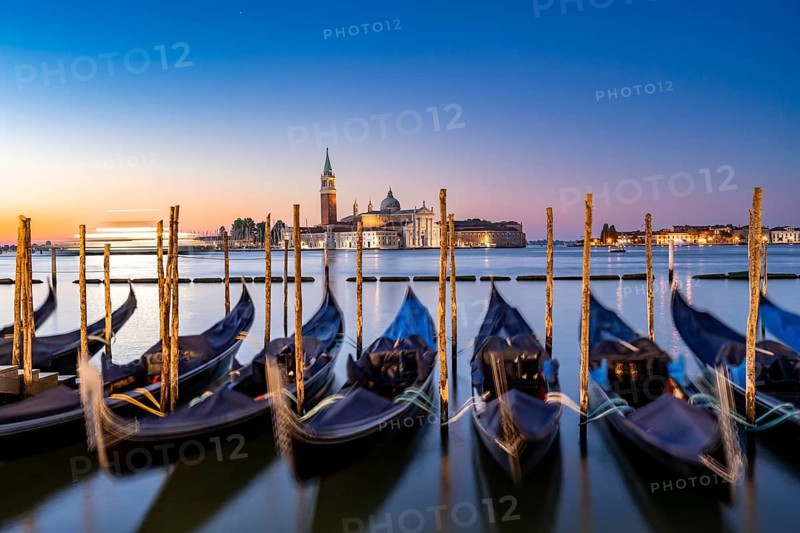 Venetian gondolas, boat dock at St Mark's Square, church of San Giorgio Maggiore in the background, long exposure at sunrise, Venice, Veneto, Italy, Europe