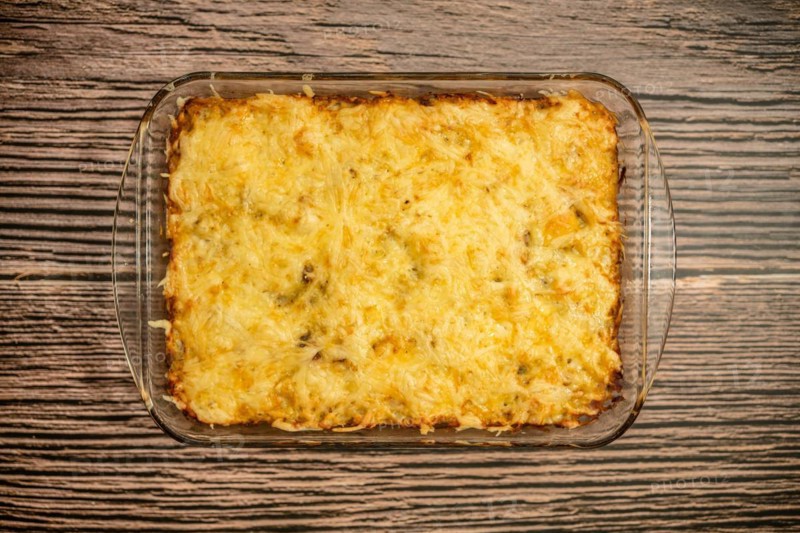 Top view of pie with meat and potato baked in oven in glass baking tray