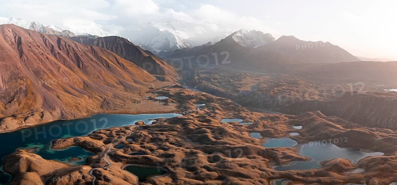 Atmospheric aerial view, high mountain landscape with glacier moraines and mountain lakes, behind Pik Lenin, Trans Alay Mountains, Pamir Mountains, Osher Province, Kyrgyzstan, Asia