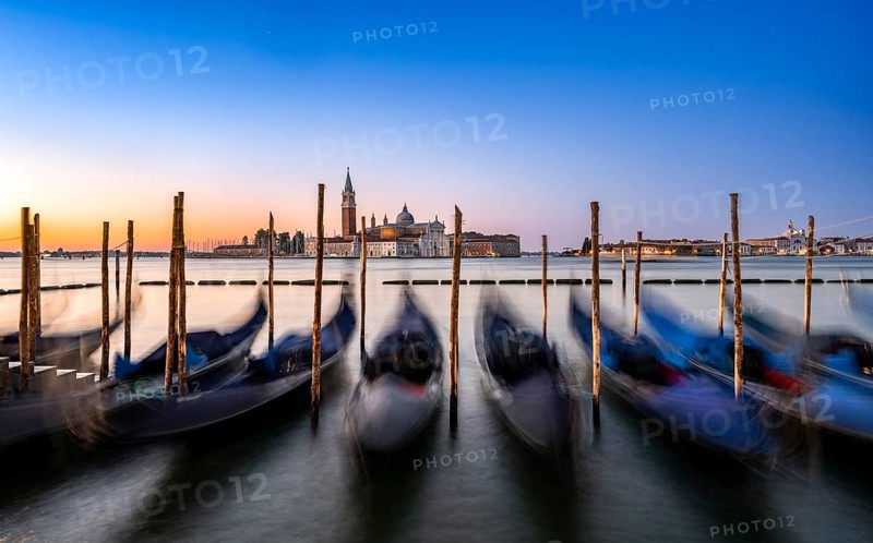 Venetian gondolas, boat dock at St Mark's Square, church of San Giorgio Maggiore in the background, long exposure at sunrise, Venice, Veneto, Italy, Europe