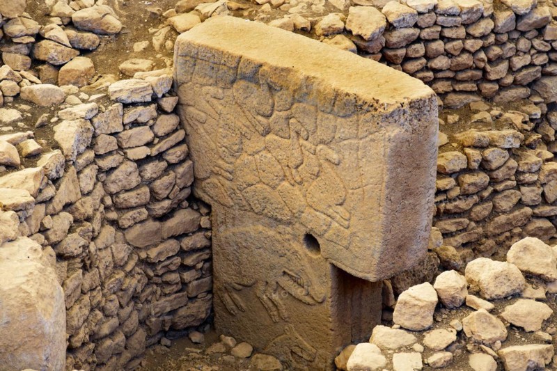 Gobekli Tepe neolithic archaeological site dating from 10 millennium BC, Massive stone pillars with sculptural relief of wild animals, Potbelly Hill, Sanliurfa, Turkey, Asia