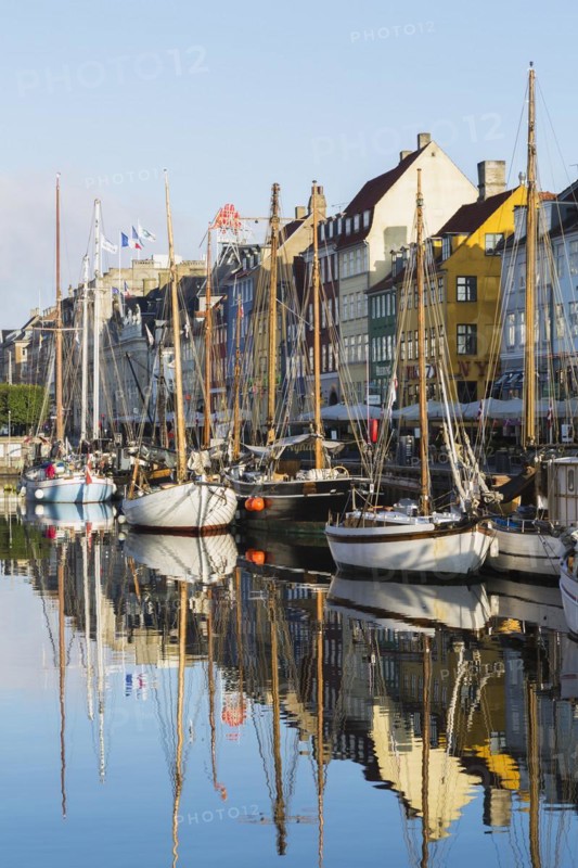 Moored sailboats and colourful 17th century apartment buildings and houses along the Nyhavn canal, Copenhagen, Denmark, Europe