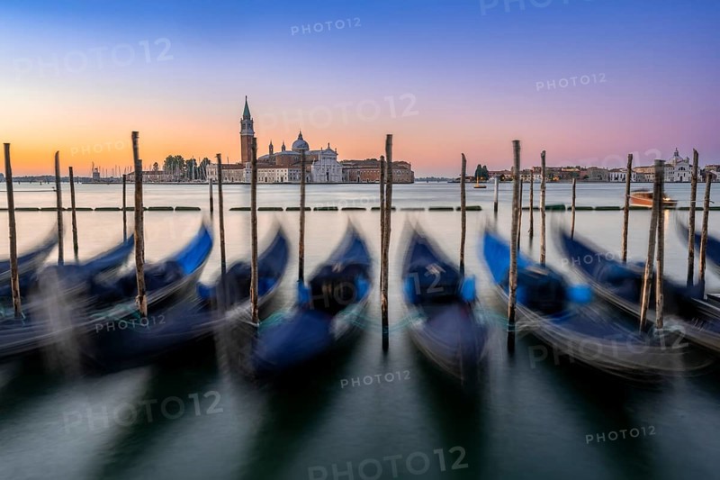 Venetian gondolas, boat dock at St Mark's Square, church of San Giorgio Maggiore in the background, long exposure at sunrise, Venice, Veneto, Italy, Europe